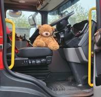 Myles in a fire truck at an owner's talk event