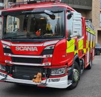 Myles in a fire truck at an owner's talk event